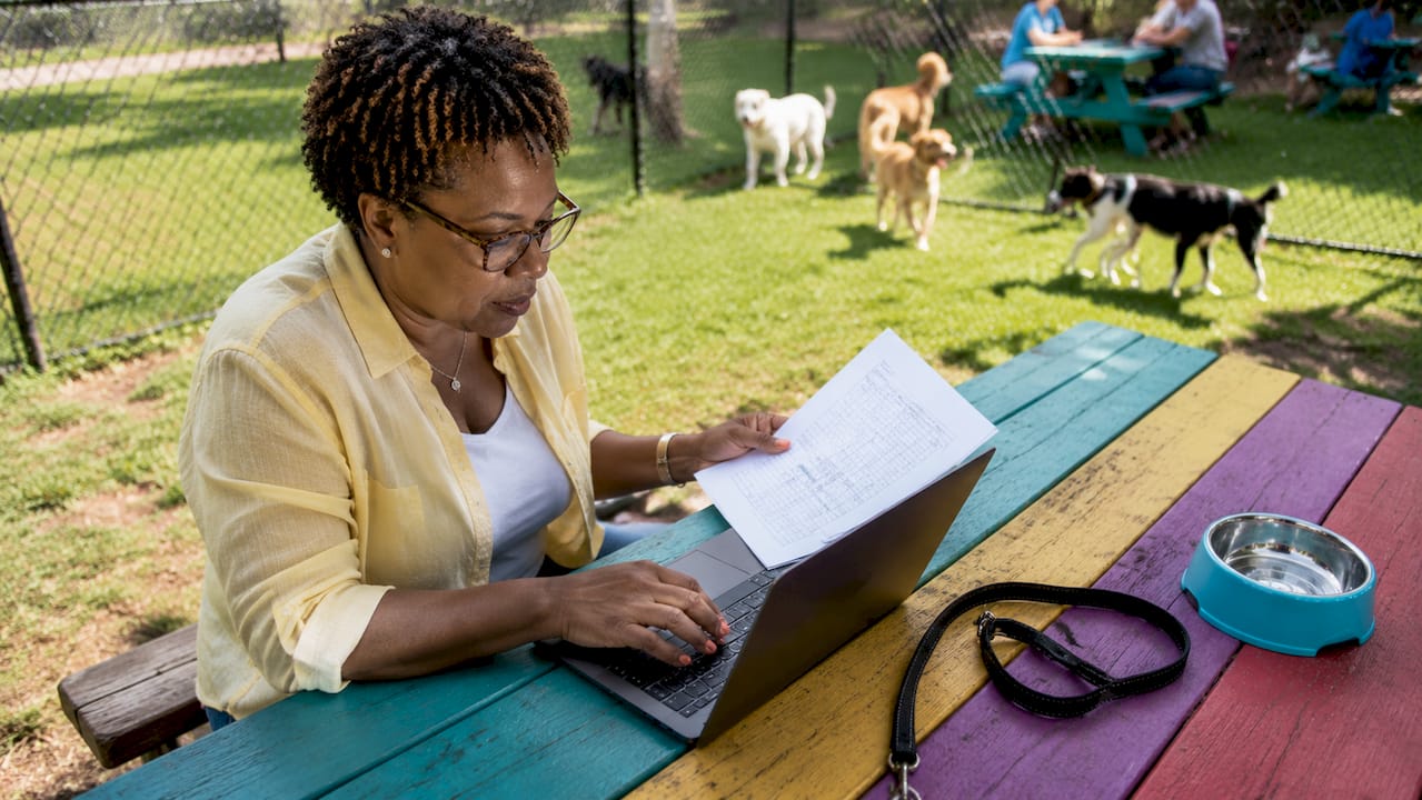 Woman reviewing pet tech records in shelter office